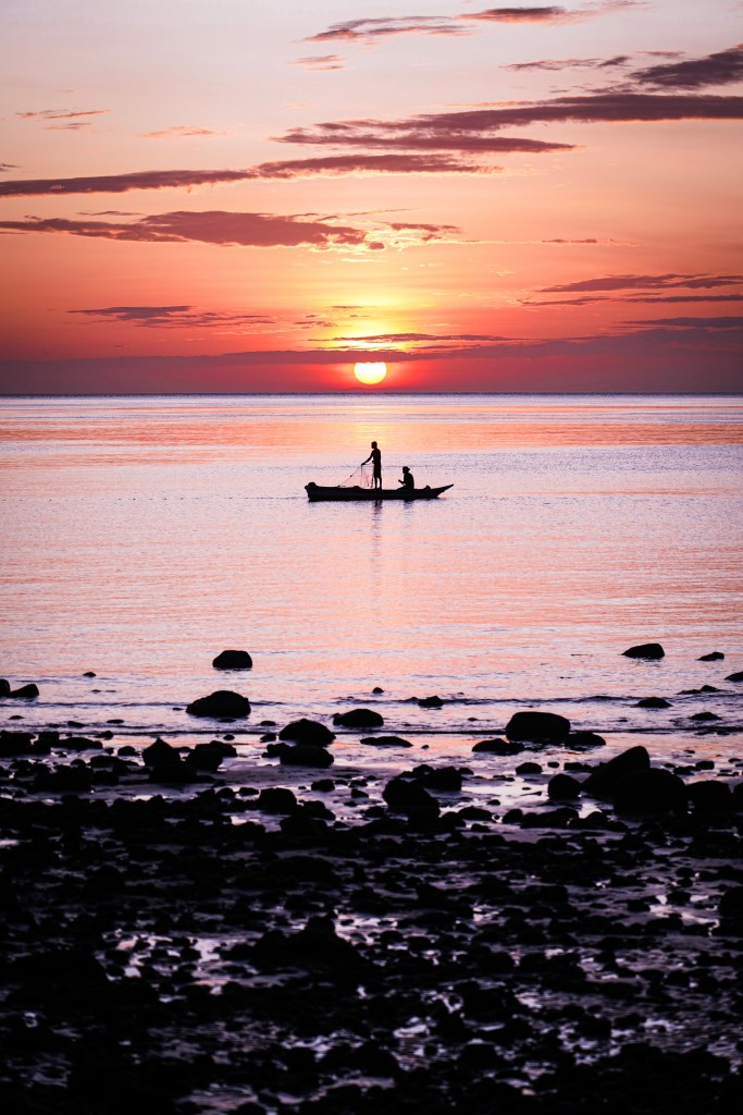 Traditional fishers with sunrise background